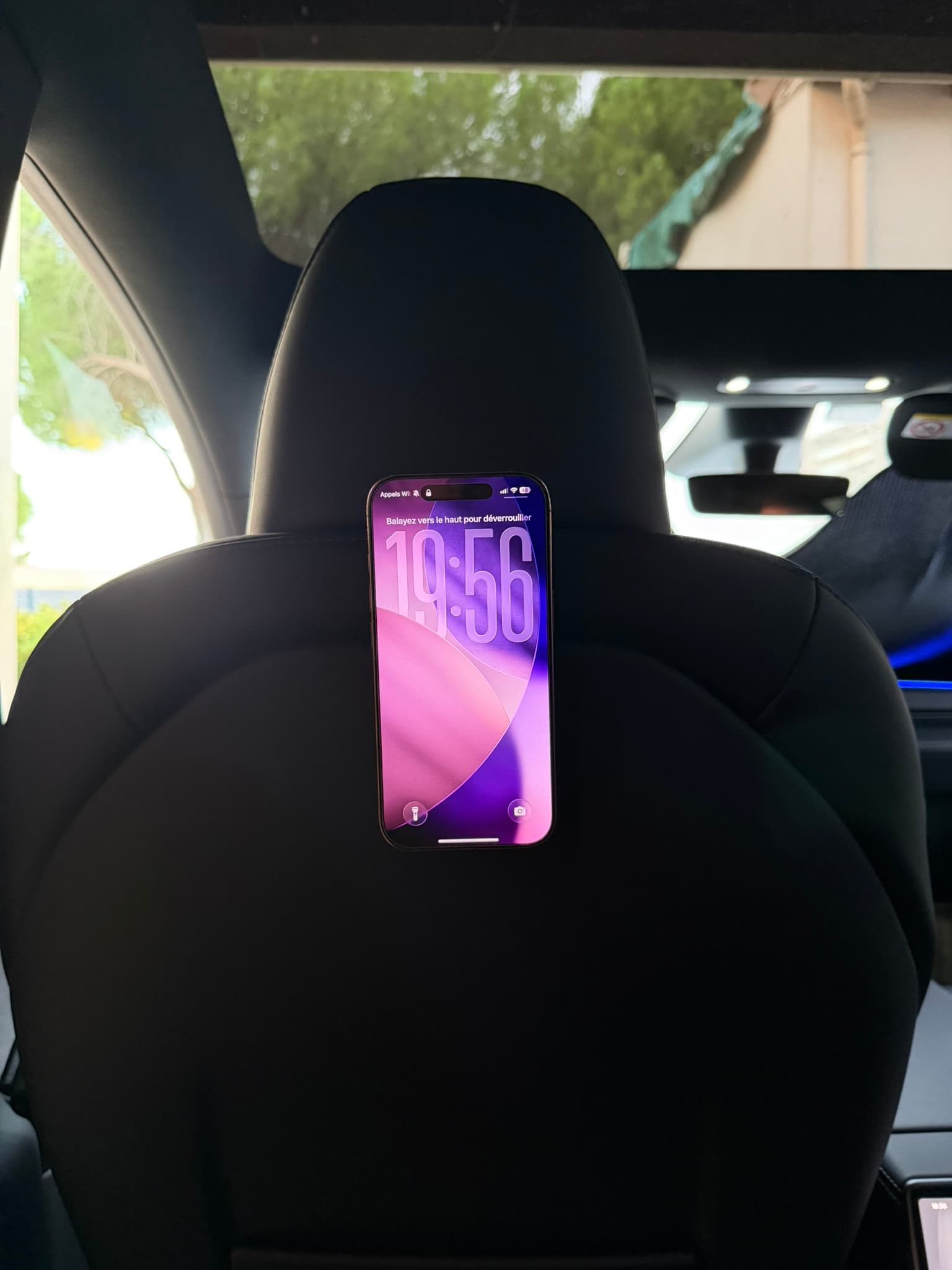 iPhone maintenu par le support magnétique Jowua au dos d'un siège avant de ma Tesla Model Y Juniper, vu depuis la banquette arrière